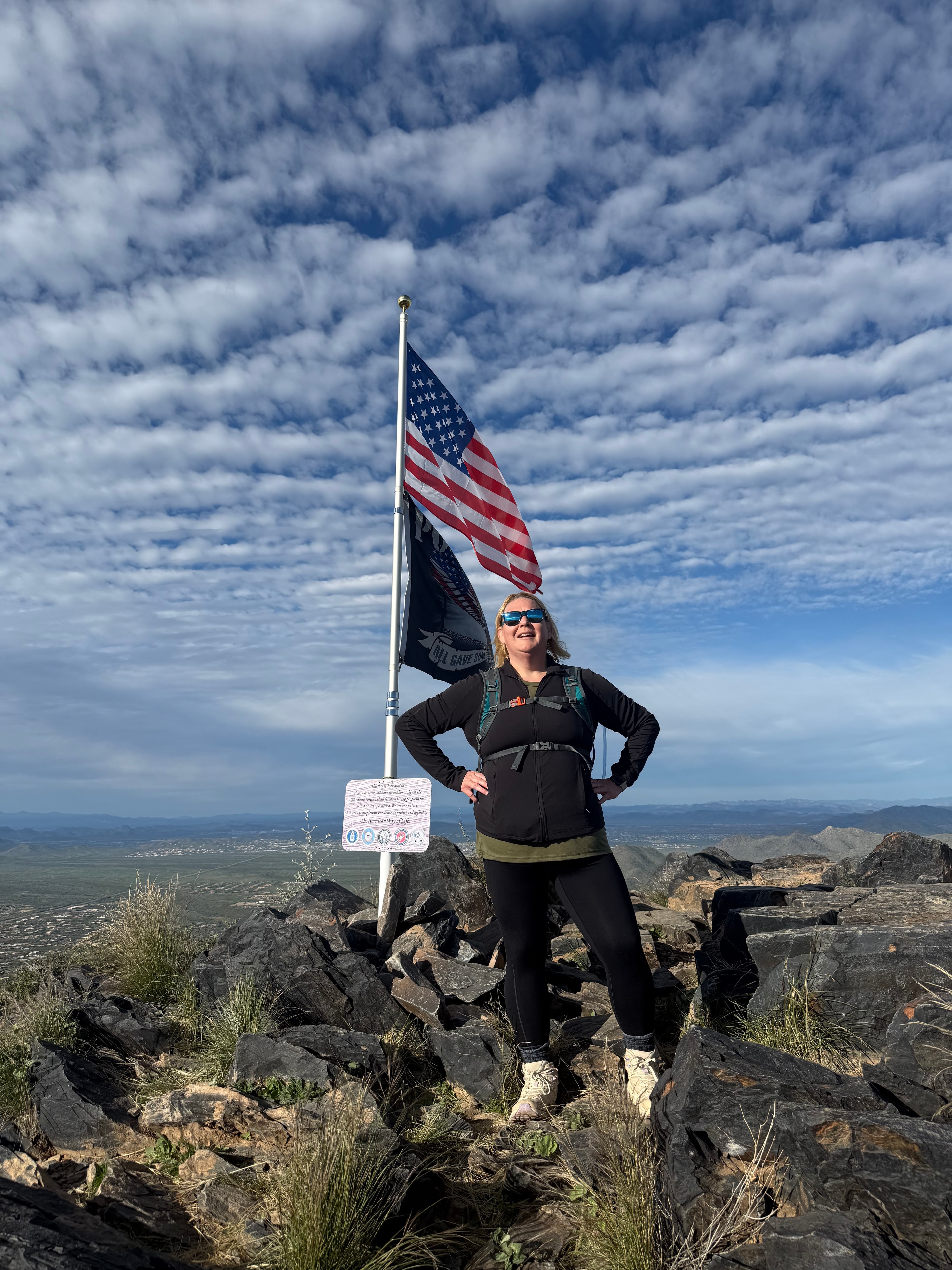 Bethanie hiking in the Arizona desert with an American flag